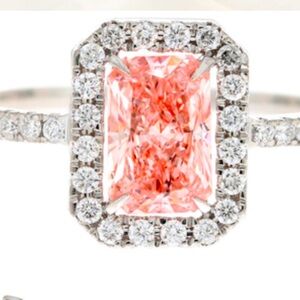 A one carat fancy vivid intense, pink diamond center stone, surround. 28 ct